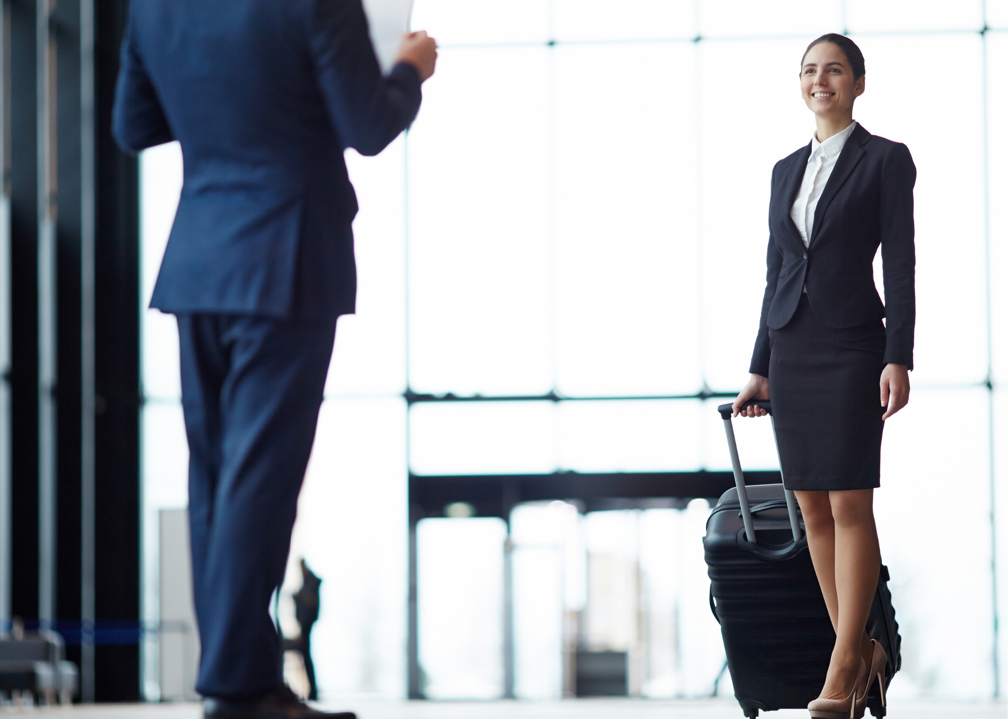 Professional female airport agent from Istanbul Meet and Greet Services welcoming a business traveler upon arrival.