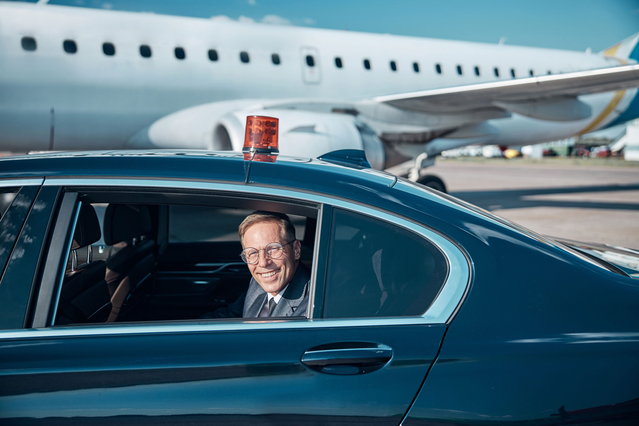 happy-elegant-man-coming-to-plane-by-car-2024-10-19-21-40-02-utc